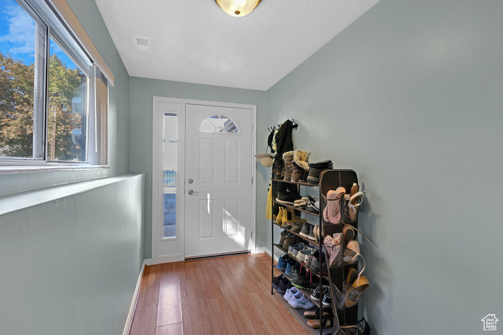 Entrance foyer with light wood-type flooring