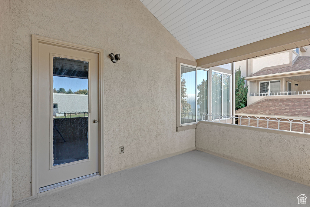 View of patio with a balcony