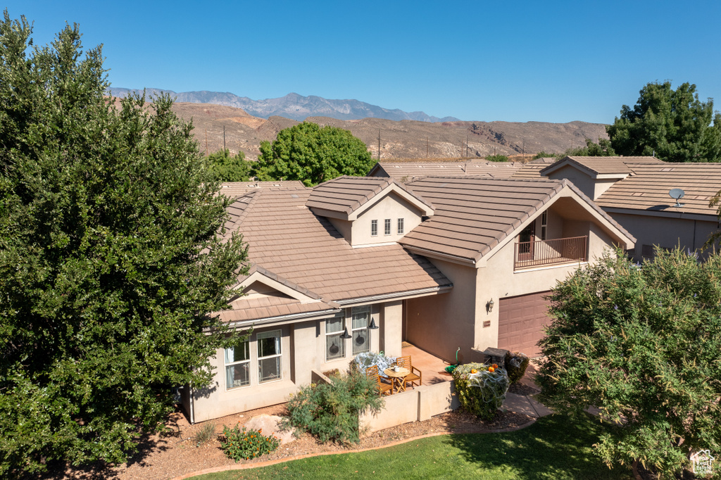 View of front of house featuring a mountain view and a garage