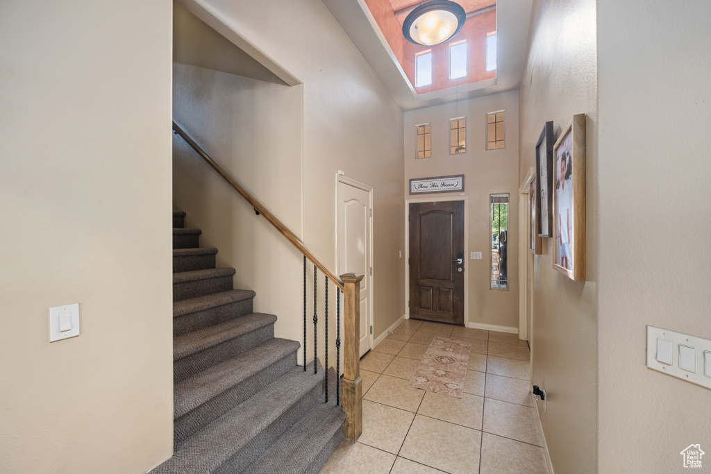 Foyer featuring high vaulted ceiling and light tile patterned floors