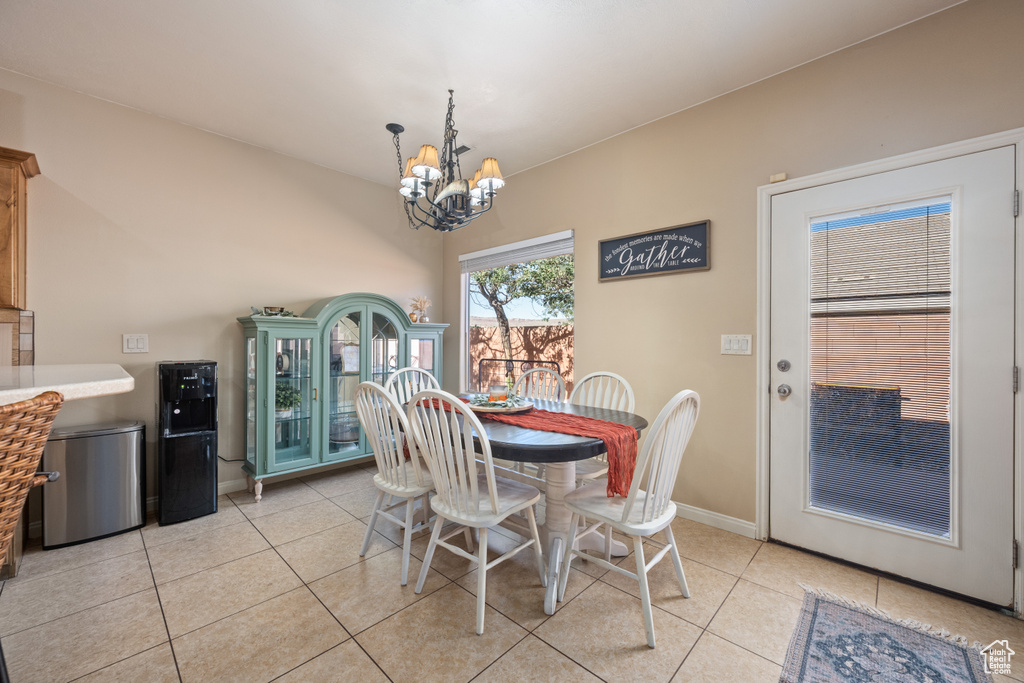 Tiled dining area with an inviting chandelier