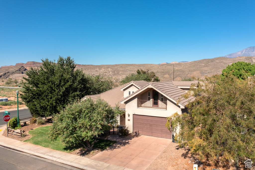 View of front facade featuring a mountain view and a garage