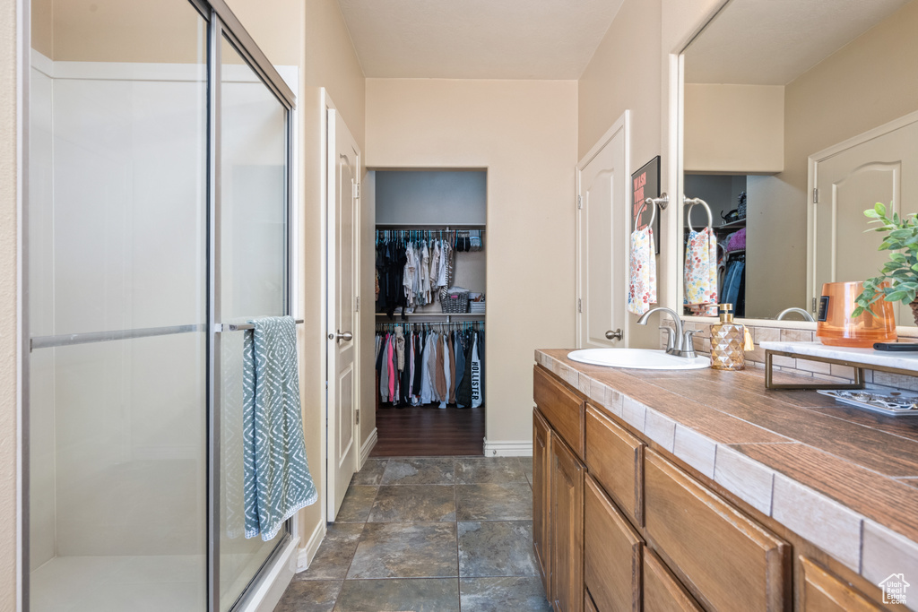 Bathroom with vanity and a shower with shower door