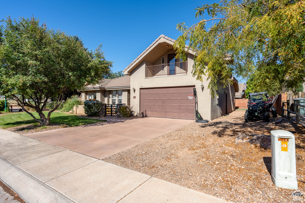 View of front of home with a balcony and a garage