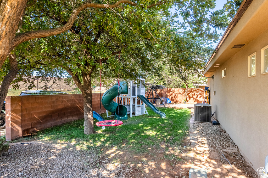 View of yard featuring a playground and cooling unit