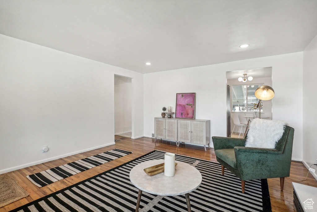 Living area featuring a chandelier and hardwood / wood-style flooring