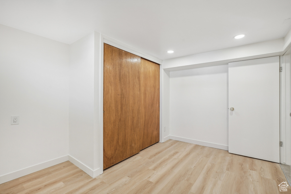 Unfurnished bedroom featuring a closet and light hardwood / wood-style flooring