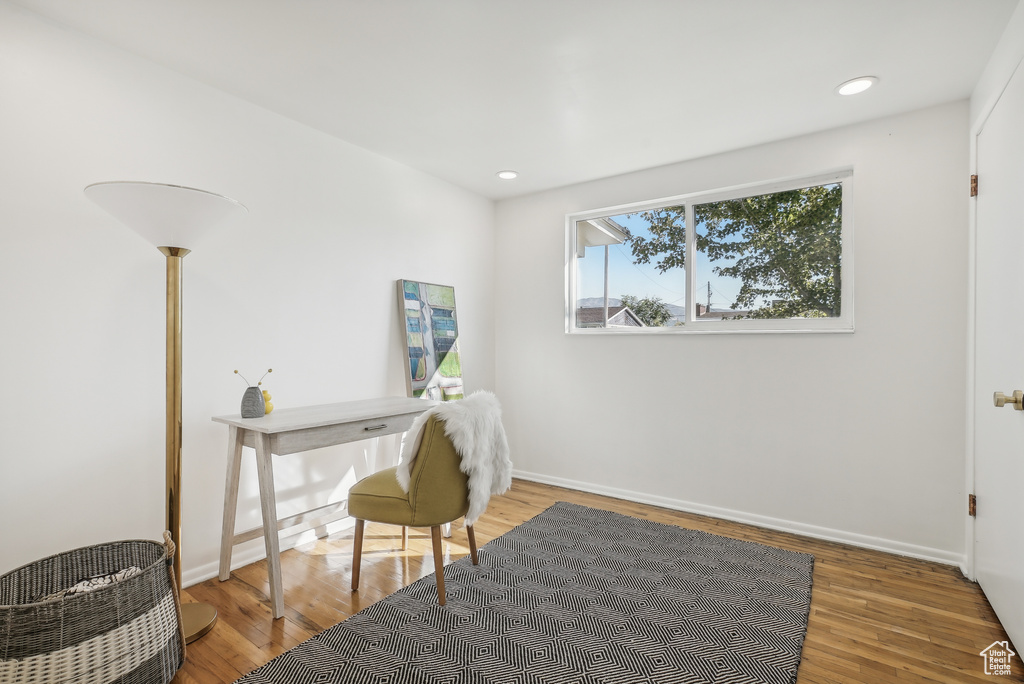 Office space with hardwood / wood-style floors