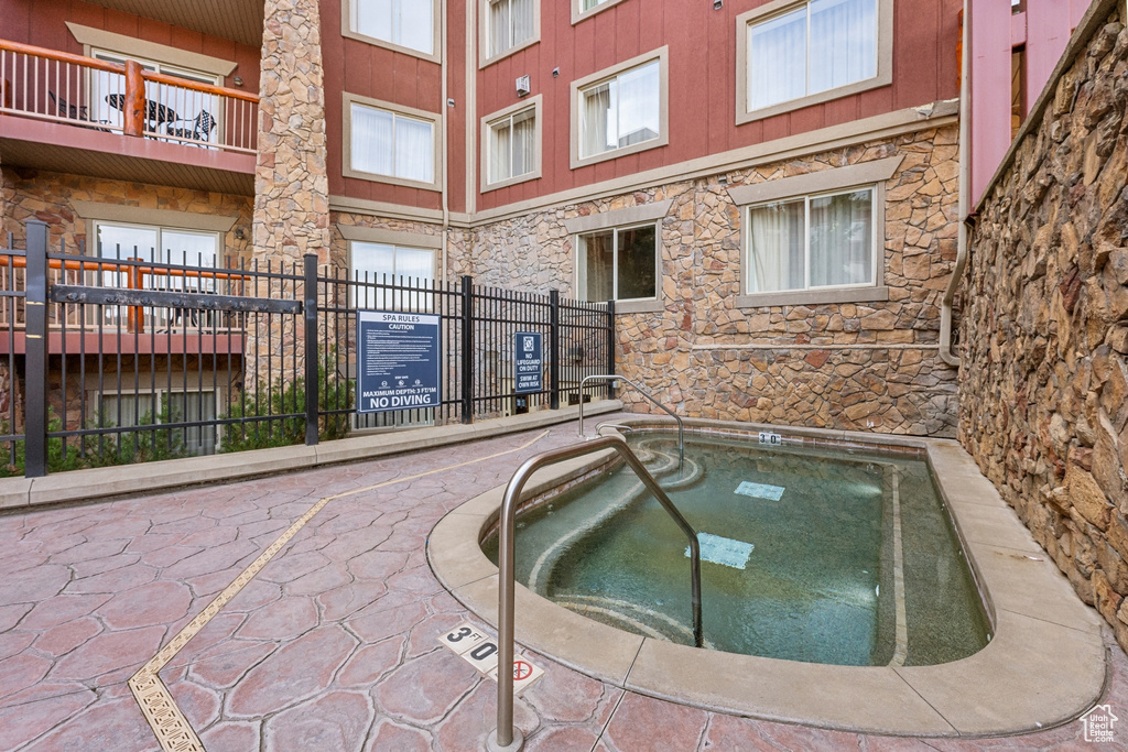 View of pool with a community hot tub