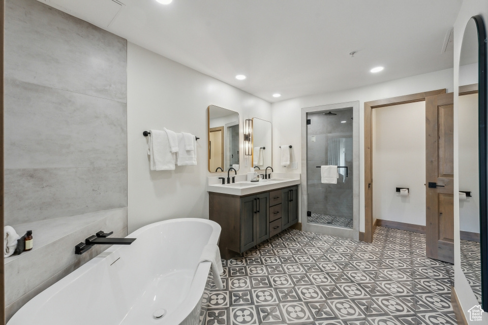 Bathroom featuring vanity and shower with separate bathtub