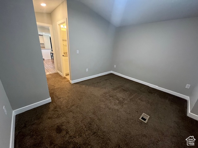 Additional living space with dark colored carpet