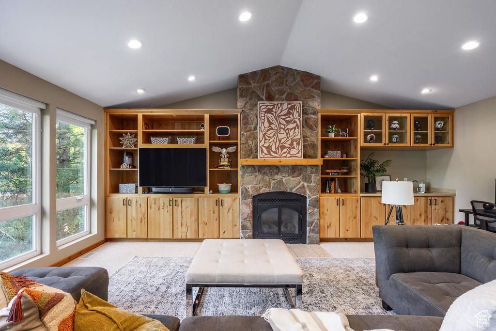 Living room featuring lofted ceiling and a fireplace