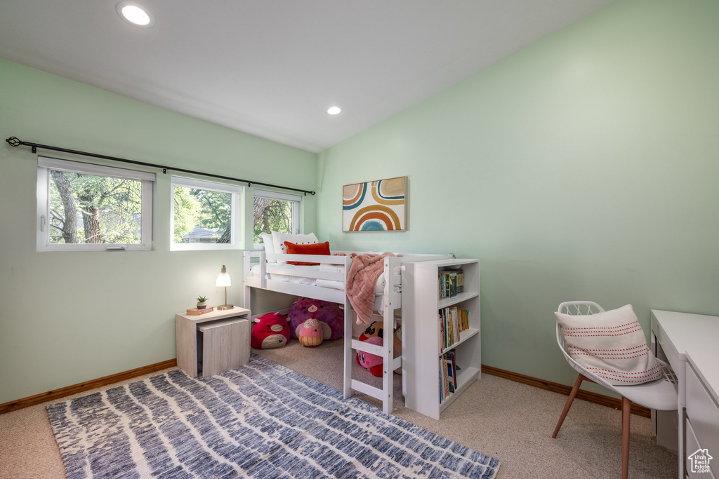 Carpeted bedroom featuring vaulted ceiling