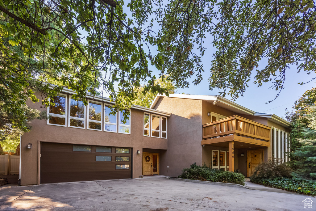 Contemporary house featuring a balcony and a garage