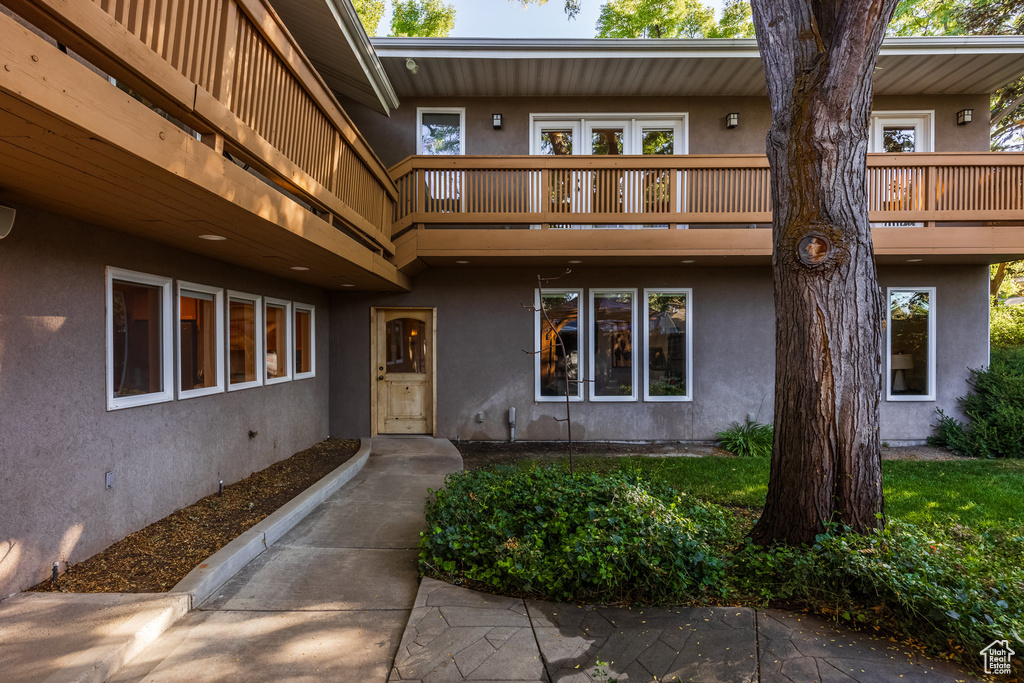 View of exterior entry featuring a balcony