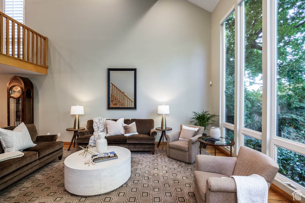 Living room with light hardwood / wood-style floors and vaulted ceiling