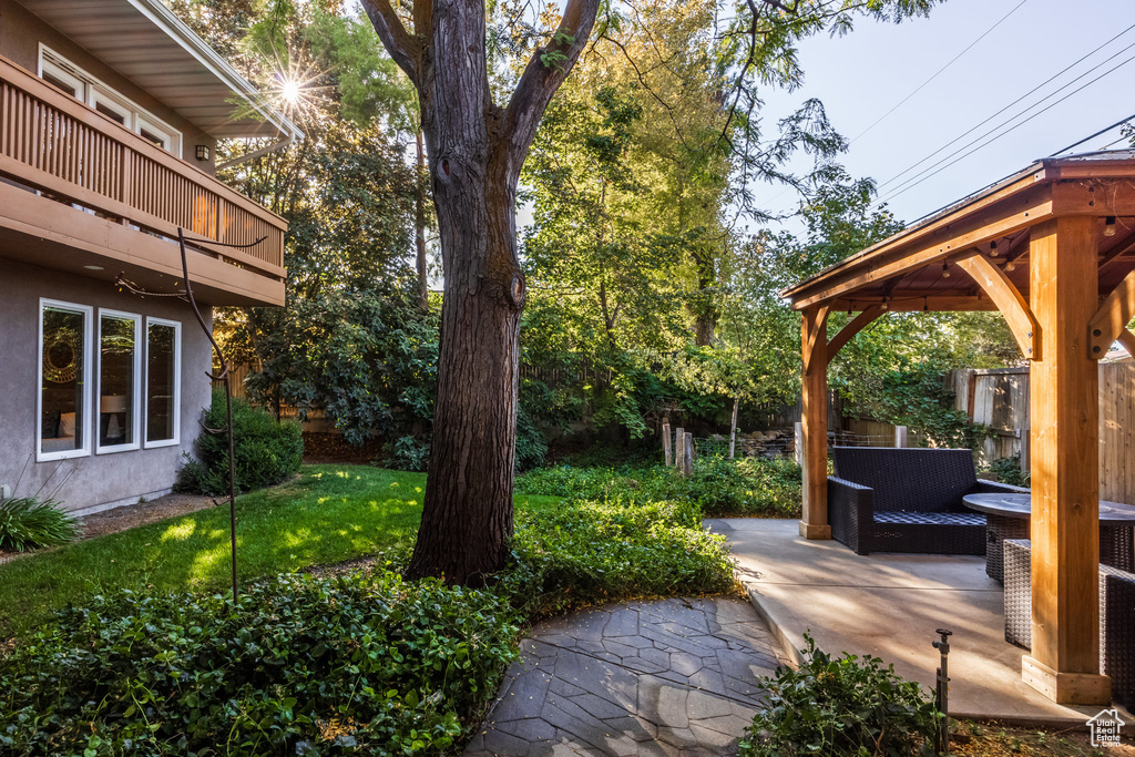 View of yard with a balcony and a gazebo