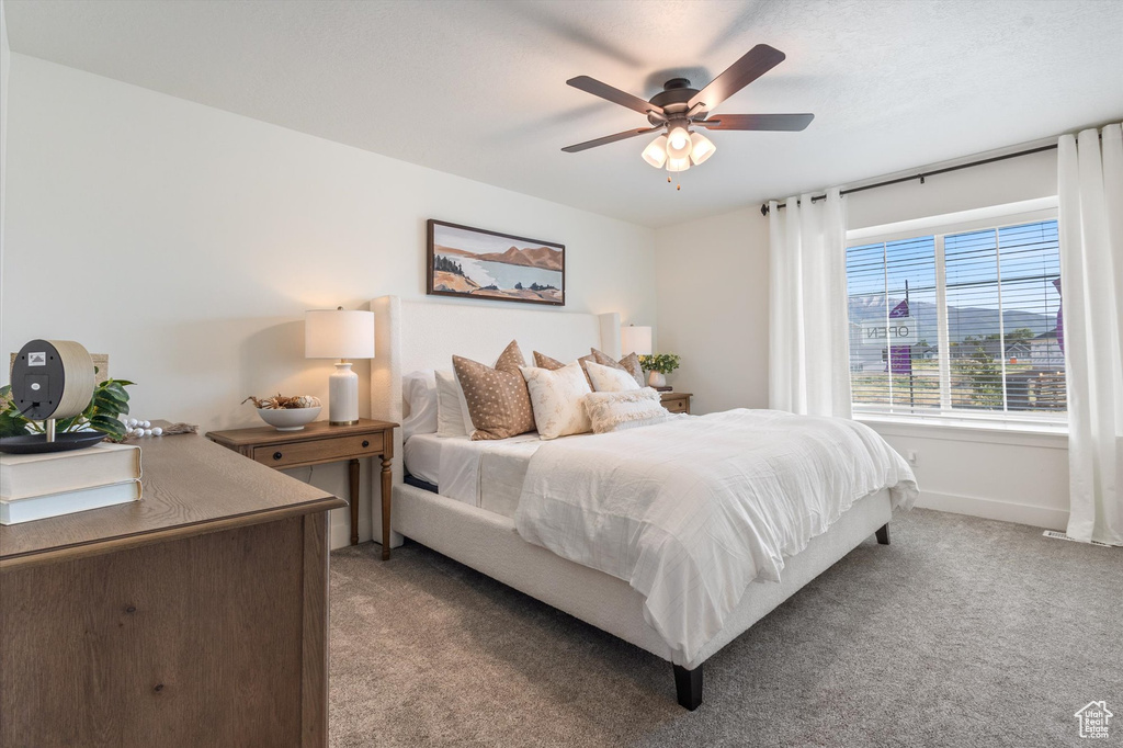 Carpeted bedroom with ceiling fan