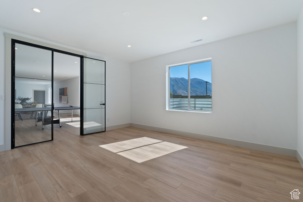 Spare room featuring light hardwood / wood-style flooring and a mountain view