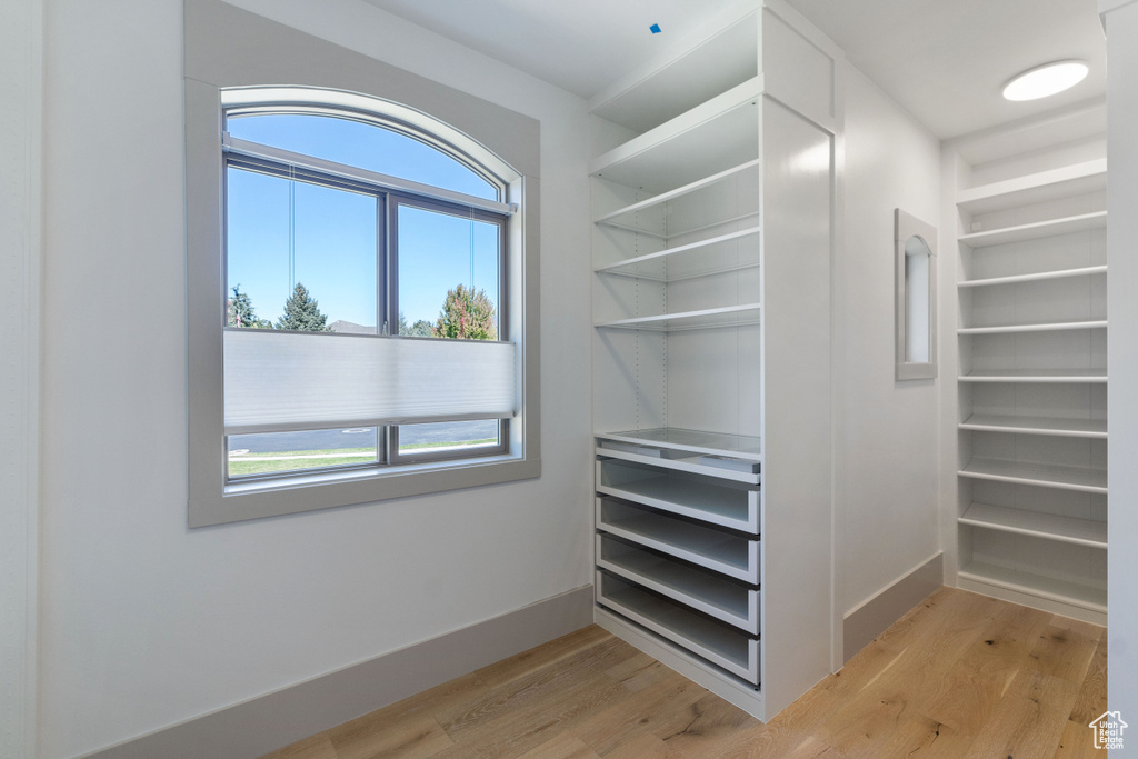 Spacious closet with light wood-type flooring