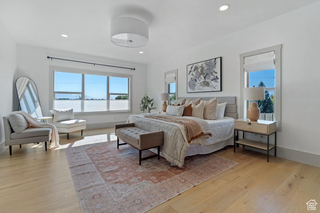 Bedroom featuring a water view and light hardwood / wood-style flooring