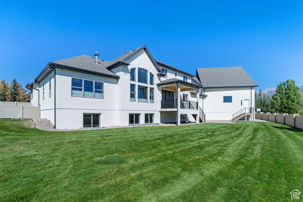 Rear view of property featuring a yard