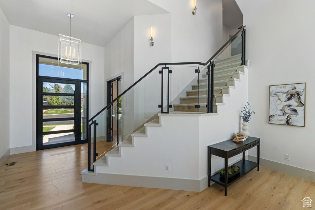 Foyer with an inviting chandelier and light wood-type flooring