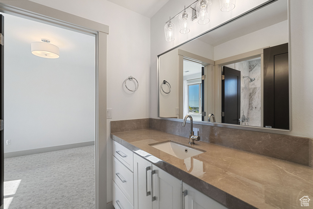 Bathroom with a tile shower and vanity