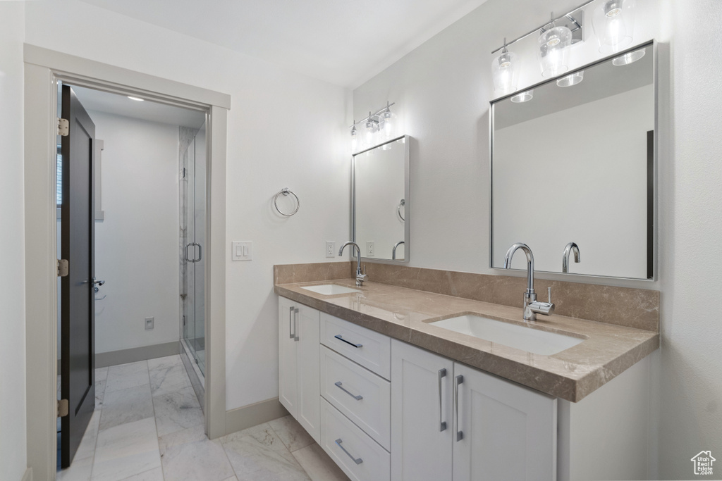 Bathroom featuring an enclosed shower and vanity