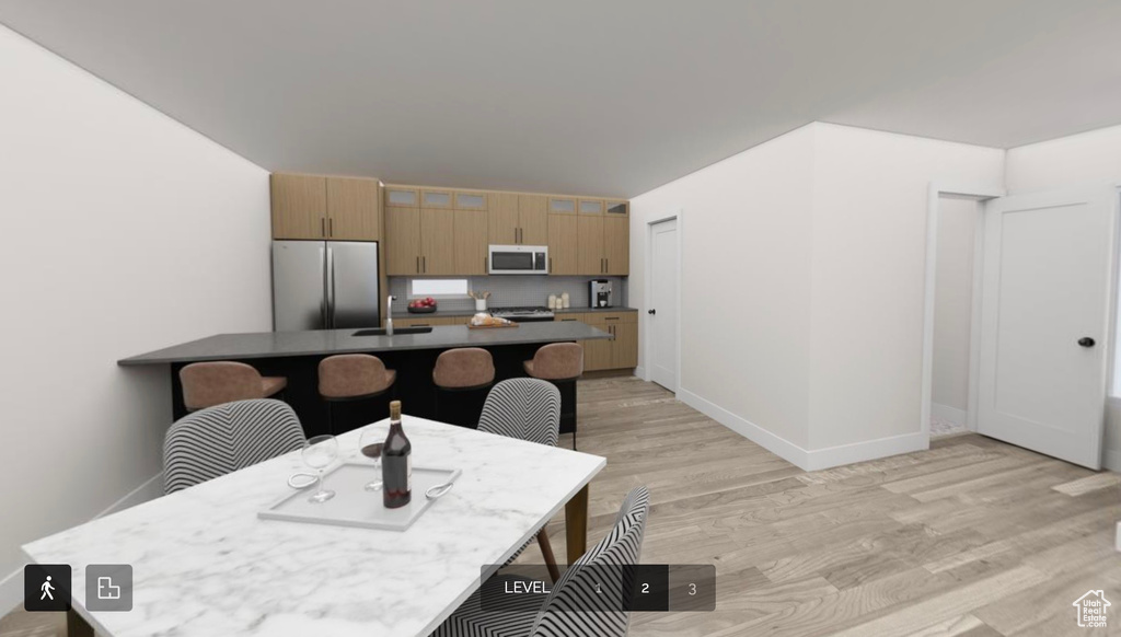 Dining room with sink and light hardwood / wood-style floors