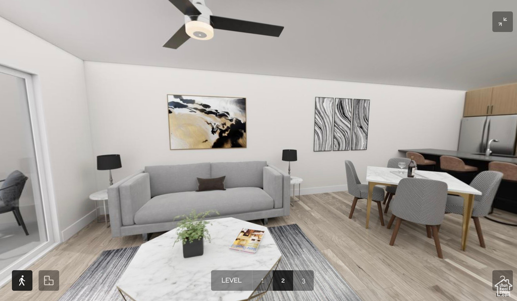 Living room featuring ceiling fan and light hardwood / wood-style floors