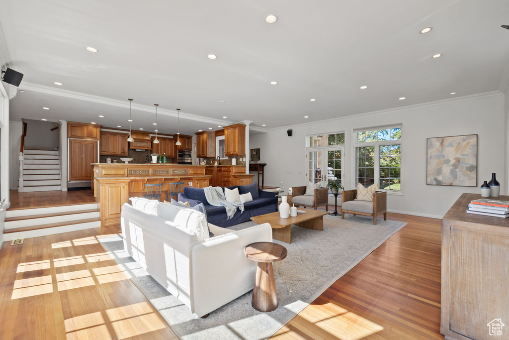 Living room featuring light hardwood / wood-style flooring and ornamental molding