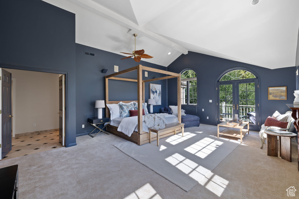 Bedroom featuring ceiling fan, beam ceiling, light carpet, and french doors