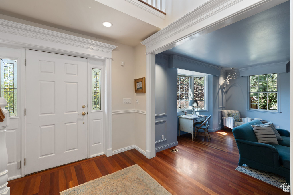 Foyer entrance with plenty of natural light and crown molding