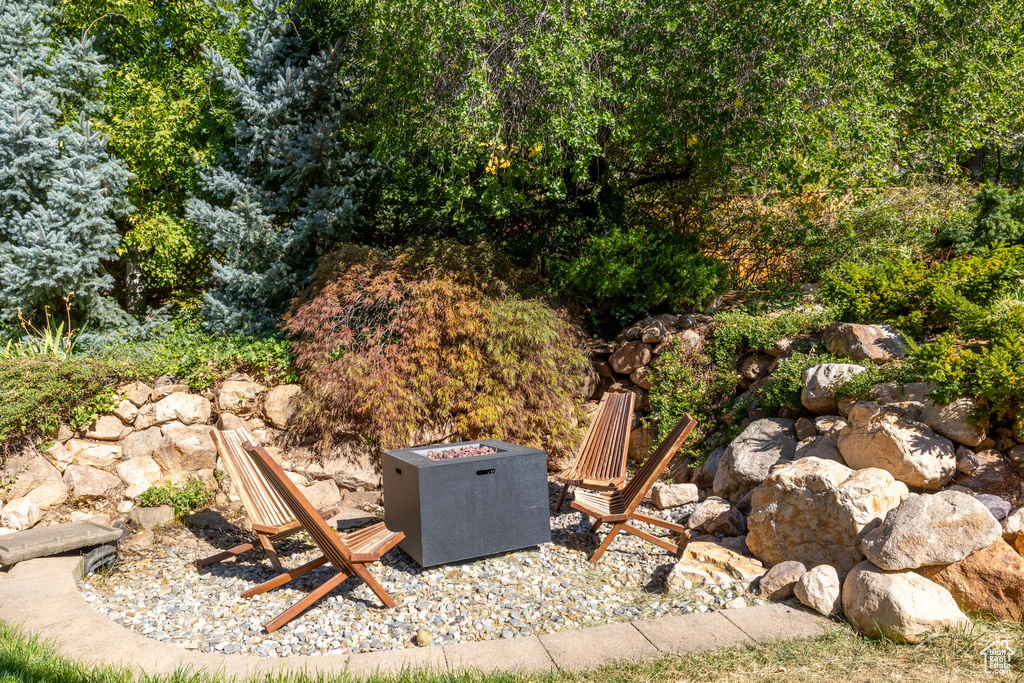 View of patio with an outdoor fire pit