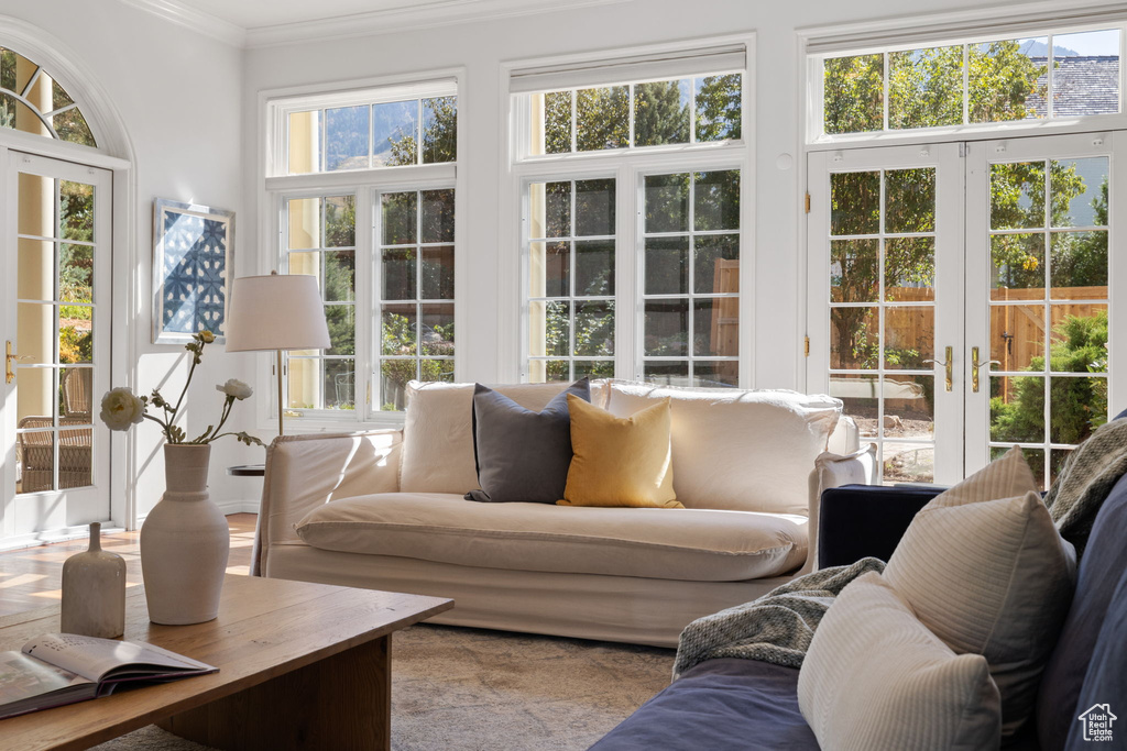 Sunroom featuring a healthy amount of sunlight and french doors