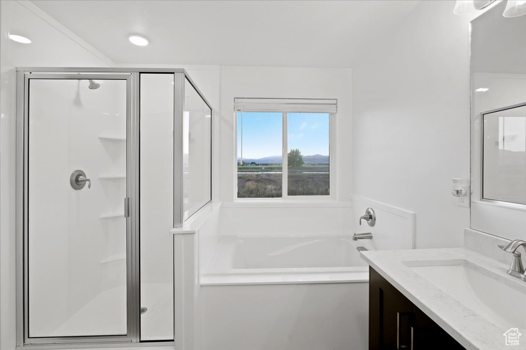 Bathroom featuring vanity and plus walk in shower