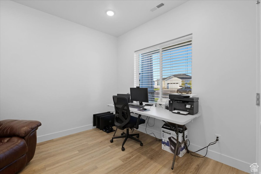 Home office with light hardwood / wood-style floors