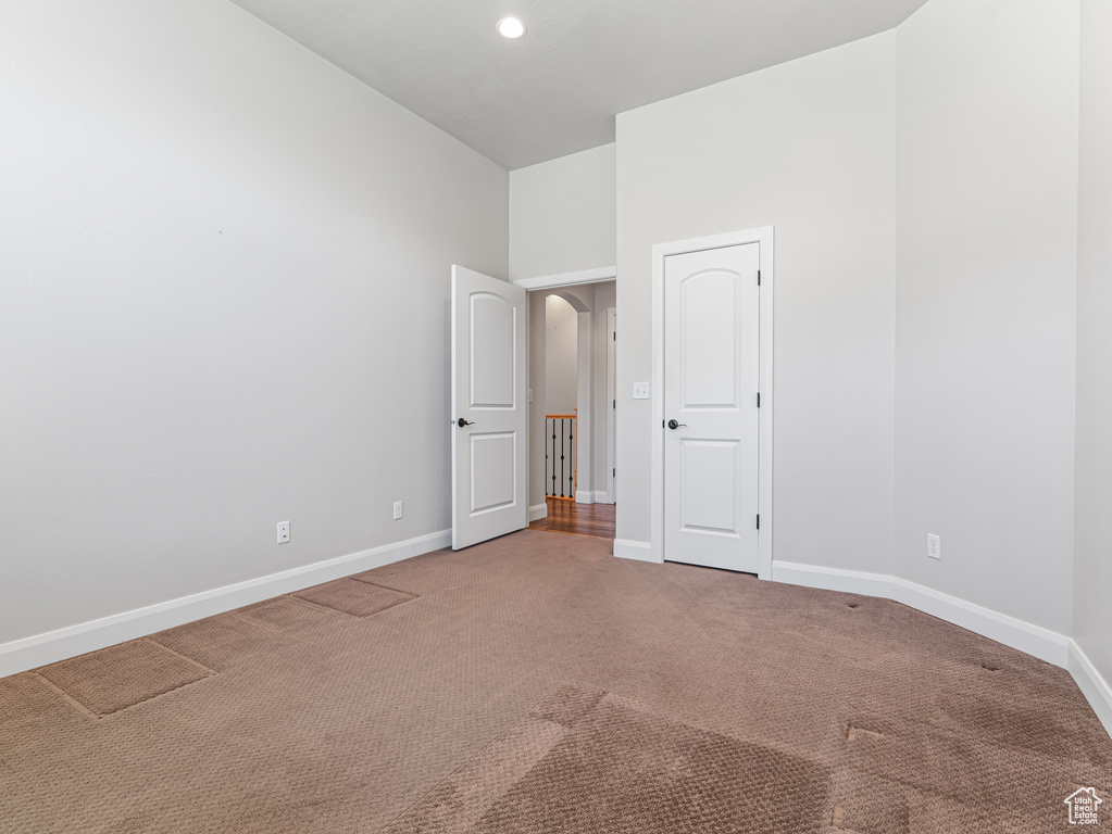 Unfurnished room with baseboards and carpet flooring