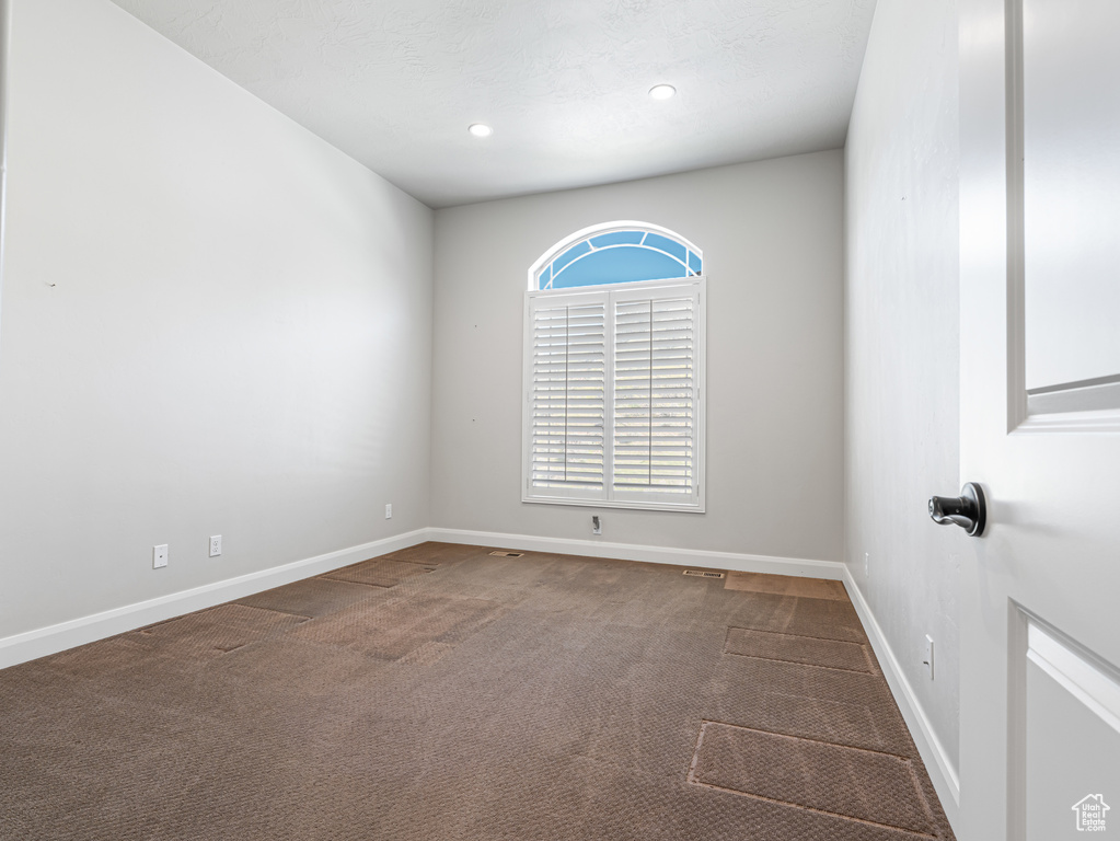 Spare room with baseboards, recessed lighting, and carpet floors