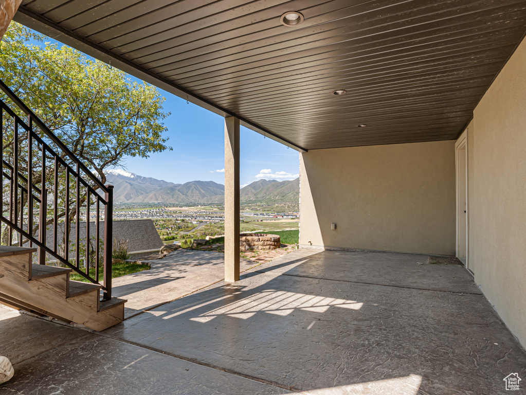 View of patio / terrace with stairway and a mountain view