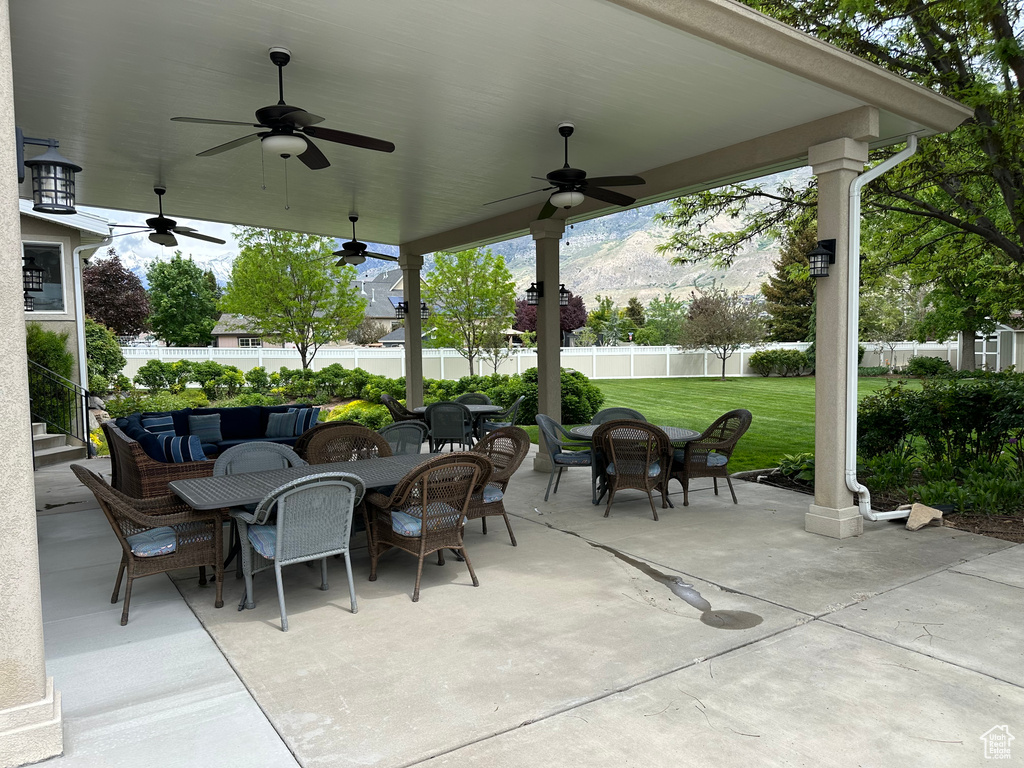 View of patio featuring outdoor dining space and ceiling fan
