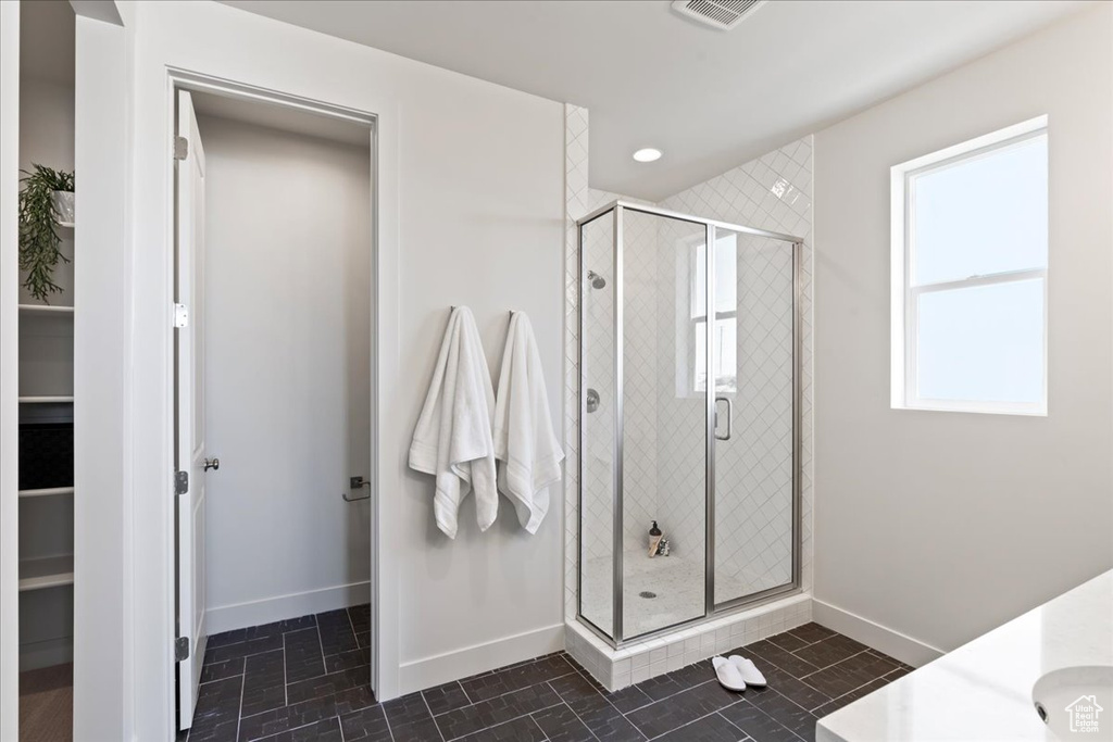 Bathroom featuring vanity and a shower with shower door