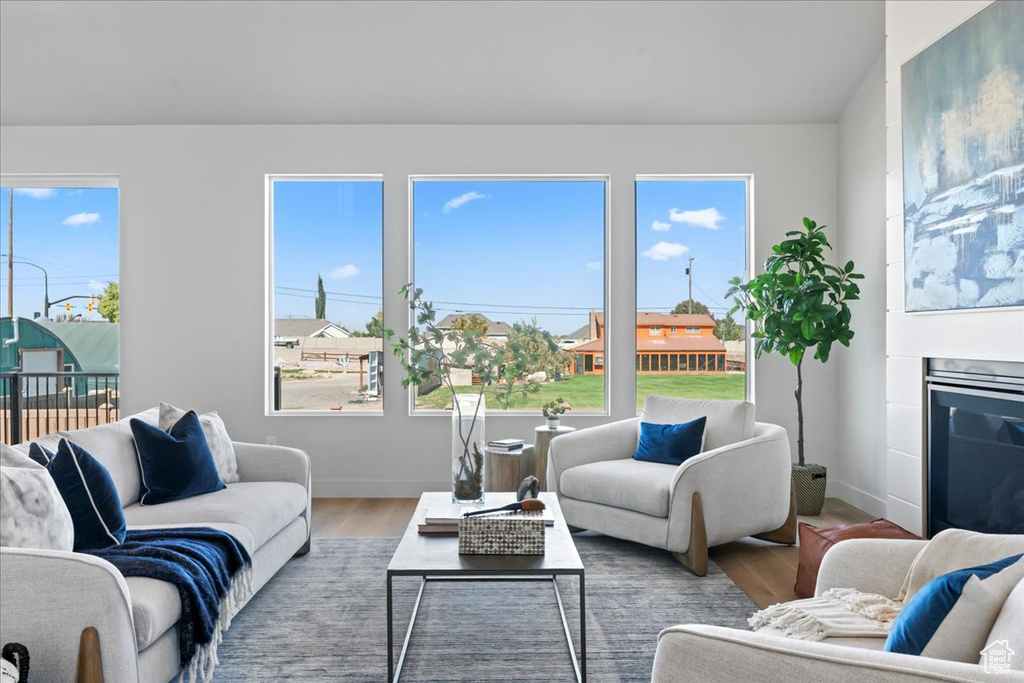 Living room featuring wood-type flooring and a wealth of natural light