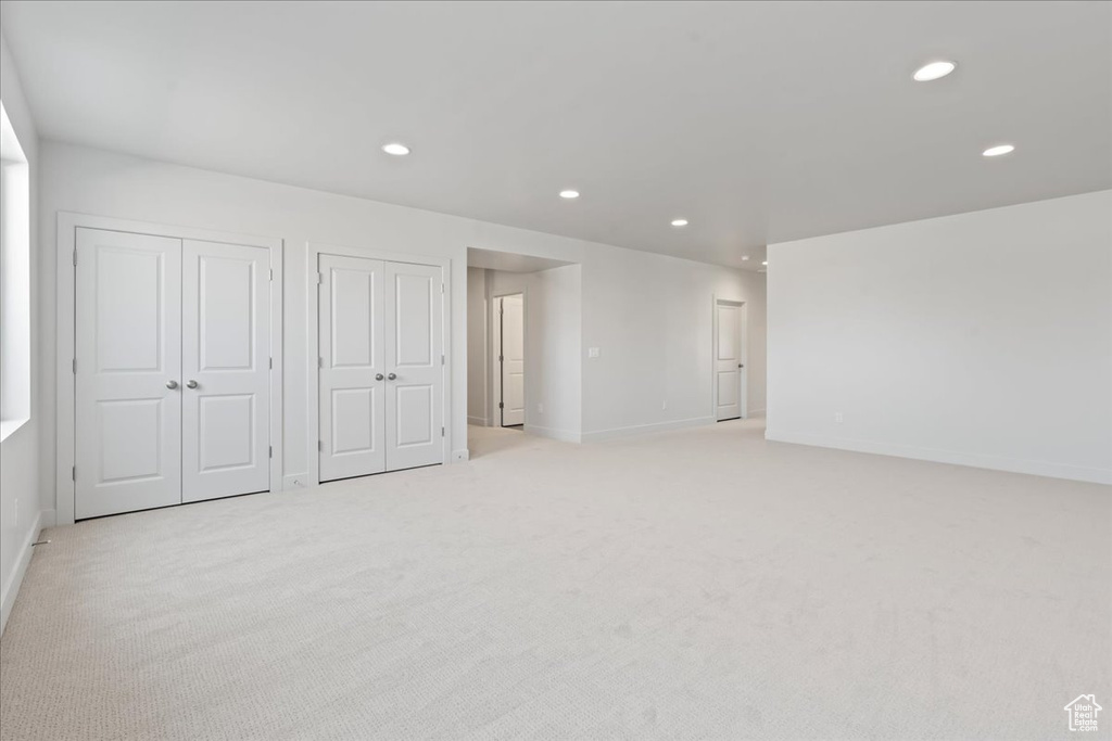 Interior space with two closets and light colored carpet