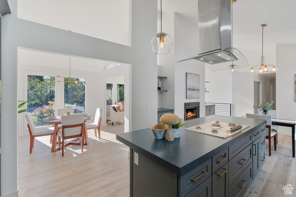 Kitchen featuring ventilation hood, pendant lighting, and light hardwood / wood-style floors