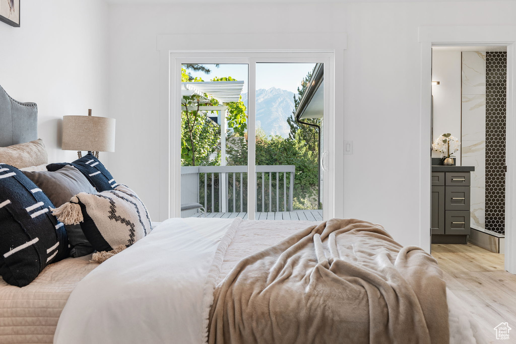 Bedroom with access to outside and light hardwood / wood-style flooring