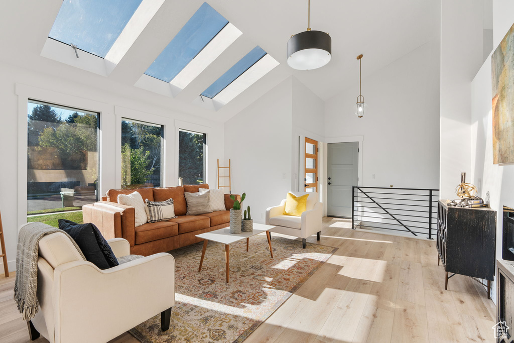 Living room featuring light hardwood / wood-style floors and high vaulted ceiling