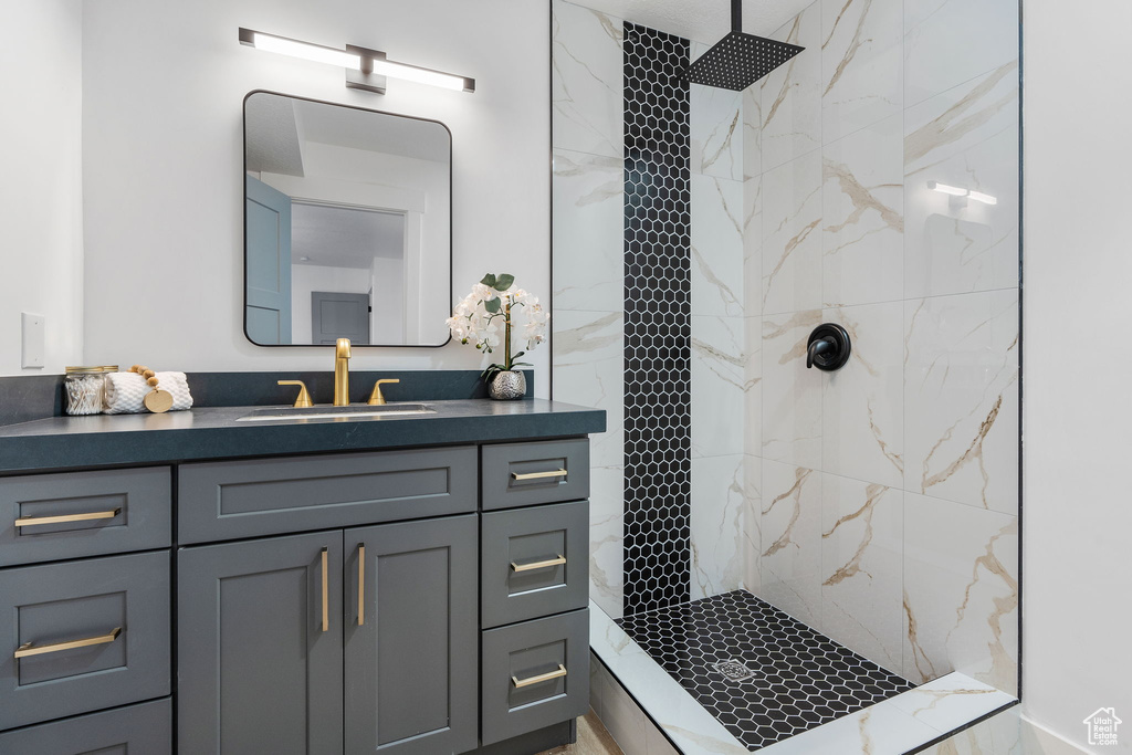 Bathroom with a tile shower and vanity