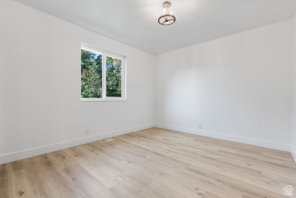 Empty room featuring light wood-type flooring